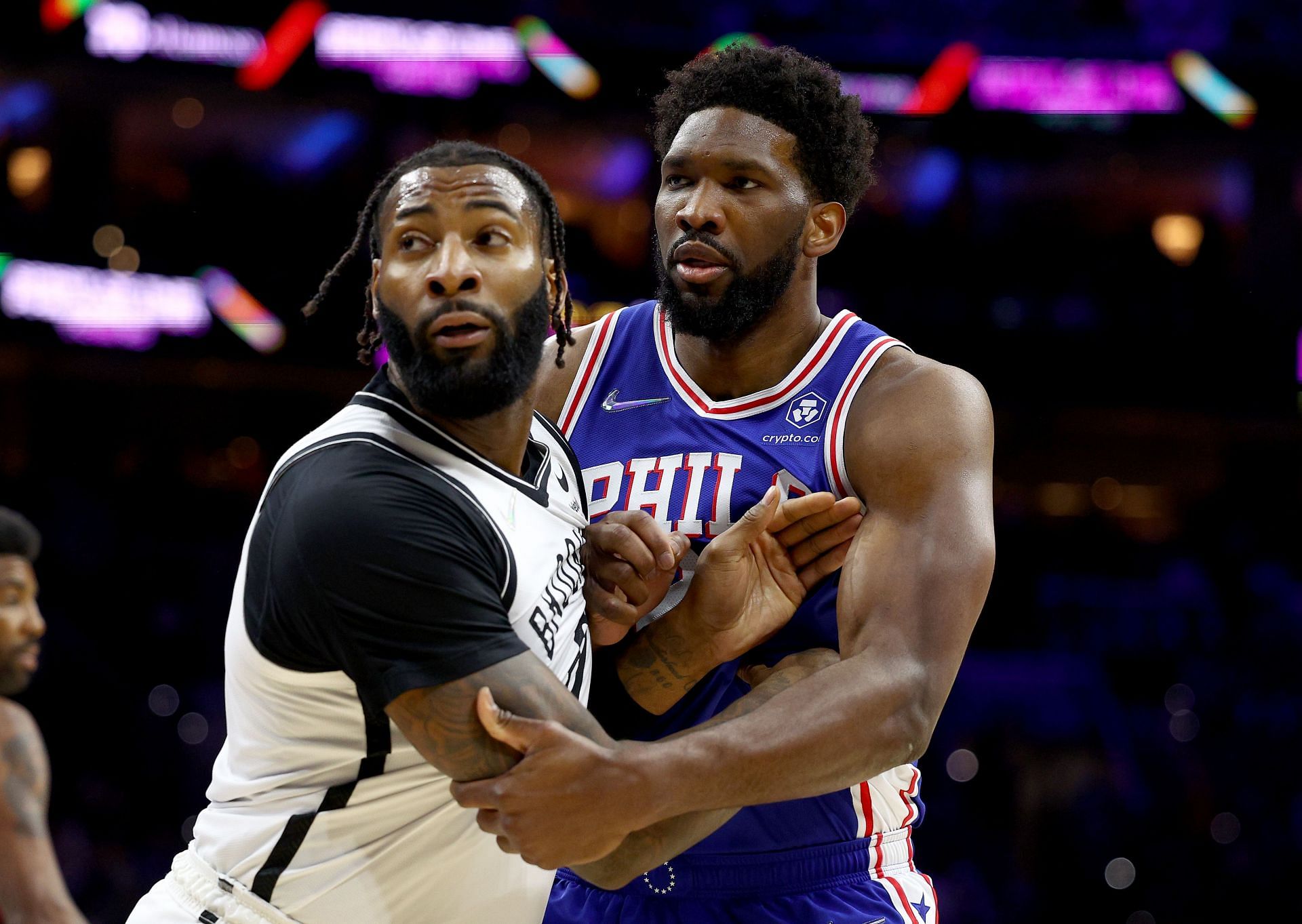 Andre Drummond #0 of the Brooklyn Nets and Joel Embiid #21 of the Philadelphia 76ers fight for position