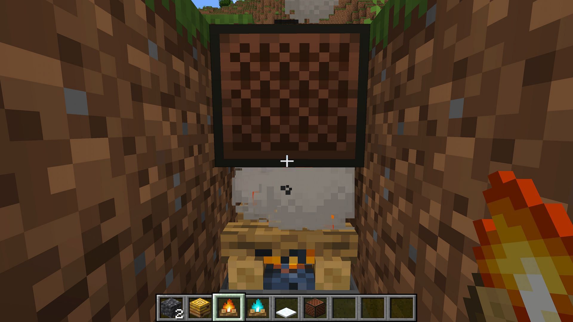 Players can change the sound of a note block using a campfire (Image via Minecraft)