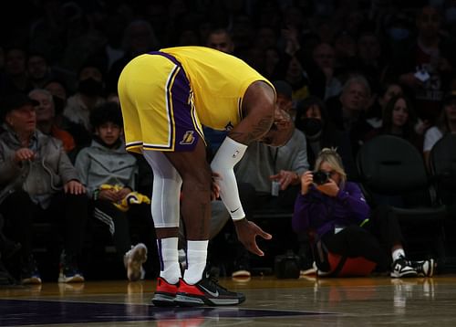 LeBron James checks for an elbow injury