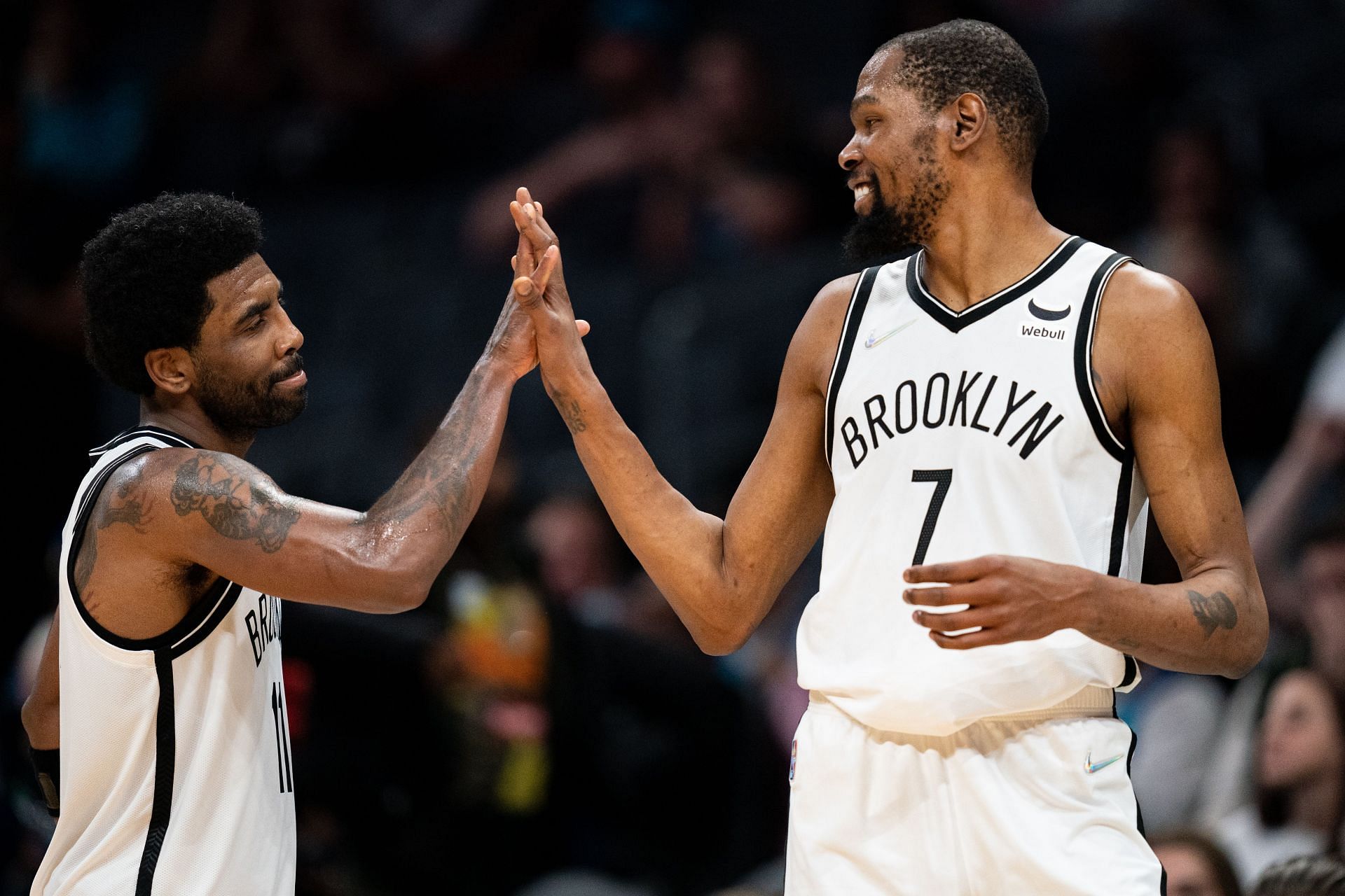 Kevin Durant #7 congratulates Kyrie Irving #11 of the Brooklyn Nets