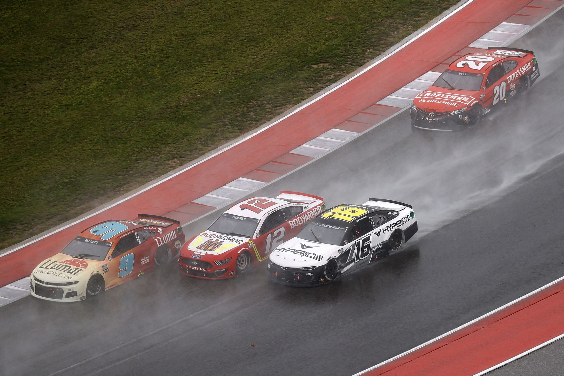 Chase Elliott, Ryan Blaney, AJ Allmendinger, and Christopher Bell race on a rain-soaked Circuit of The Americas in 2021 (Photo by Chris Graythen/Getty Images)
