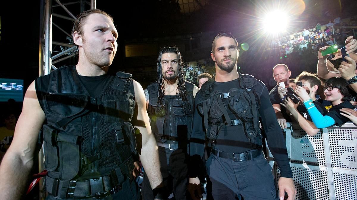 Moxley (left), Reigns (center), and Rollins (right)