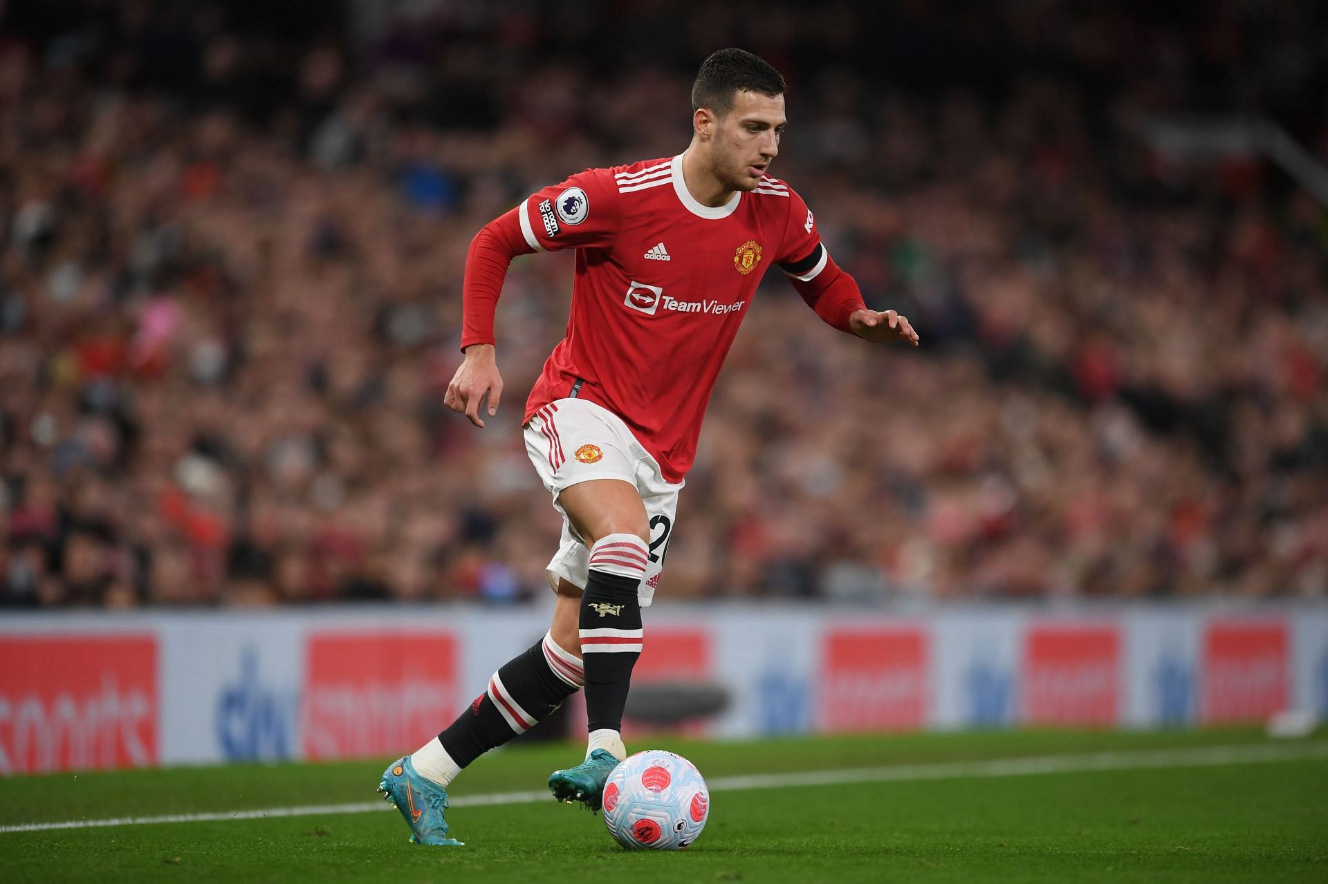 Diogo Dalot drives forward with the ball for United.