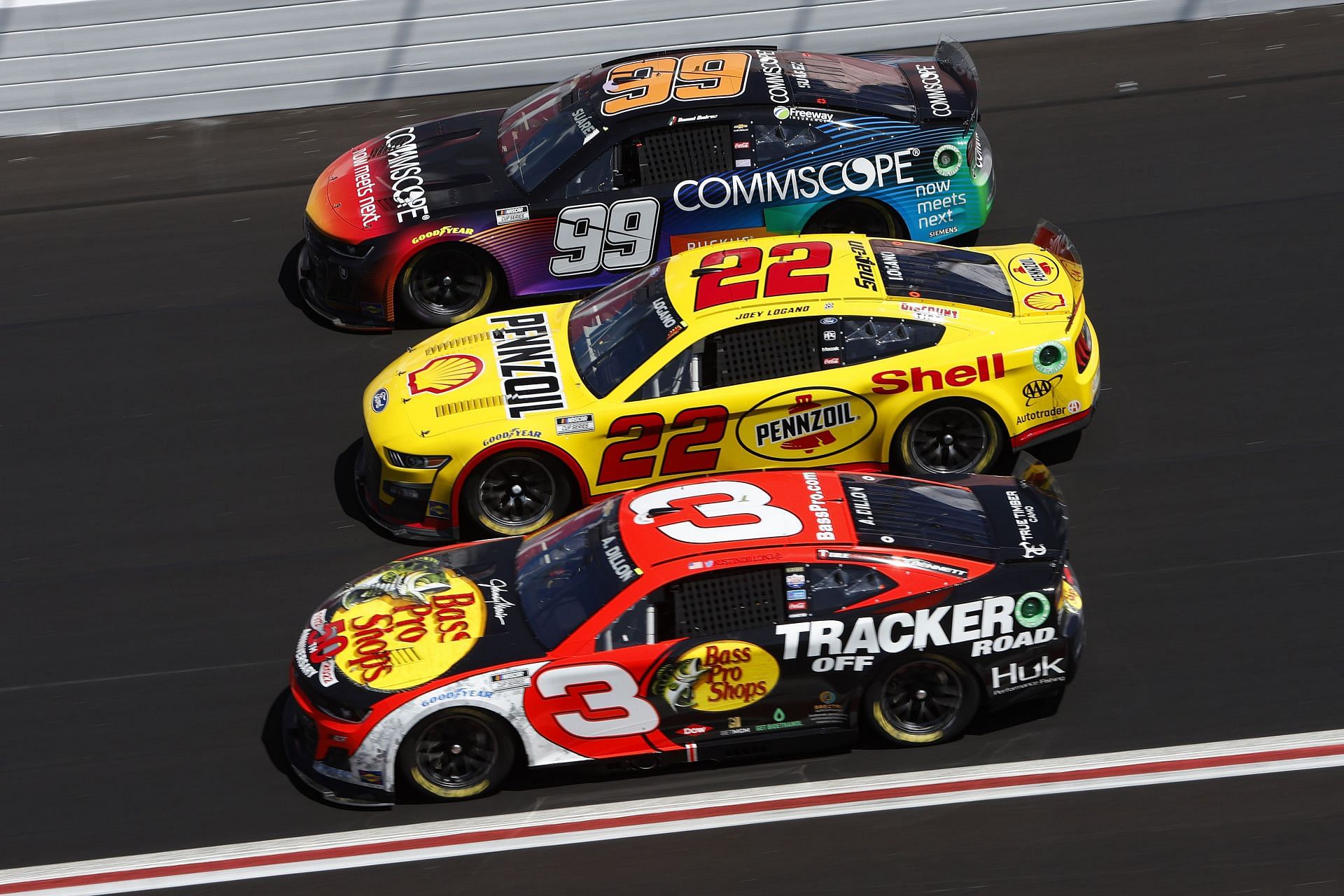 Joey Logano&#039;s No. 22 Shell Pennzoil Ford surrounded by Daniel Suarez in the No. 99 CommScope Chevrolet and Austin Dillon in the No. 3 Bass Pro Shops/Tracker Off Road Chevrolet. (Photo by Sean Gardner/Getty Images)