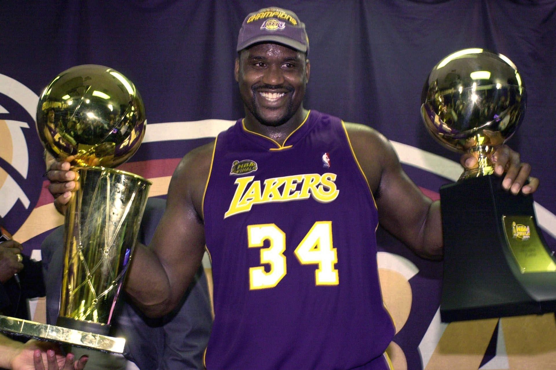 O'Neal with the NBA Finals MVP and the Larry O'Brien trophies.