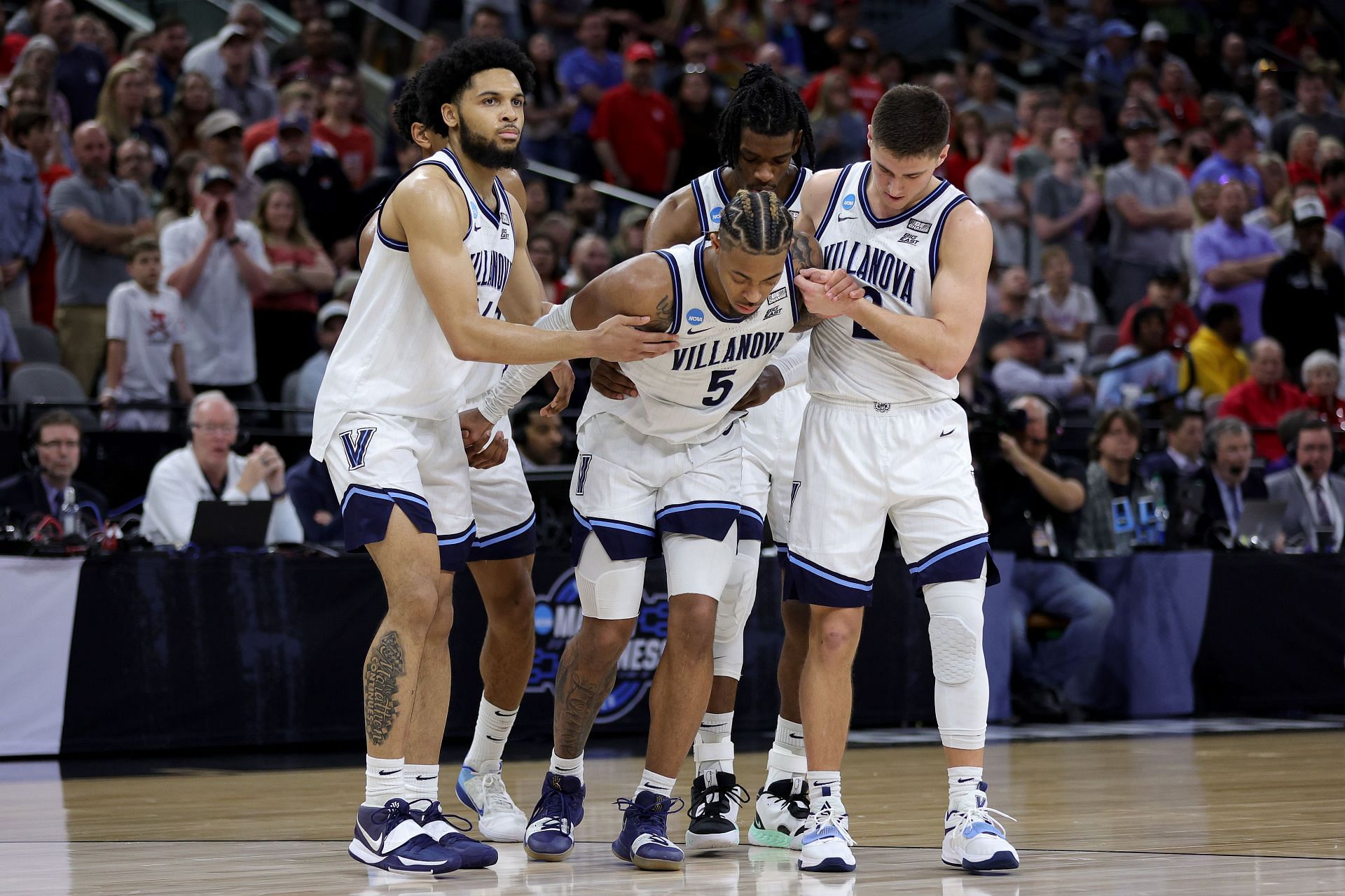 Justin Moore receives help from his Villanova teammates after a severe injury.