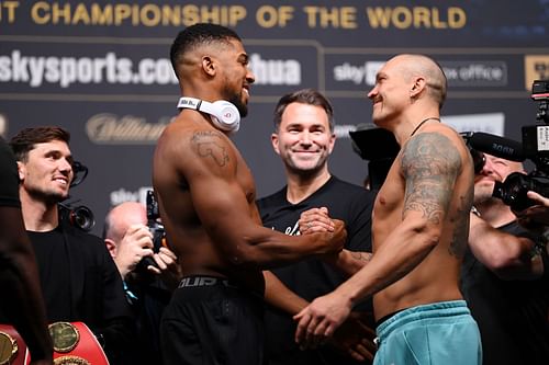 Eddie Hearn watches on as Anthony Joshua and Oleksandr Usyk embrace