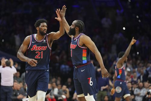 Joel Embiid #21 of the Philadelphia 76ers with teammate James Harden (#1)