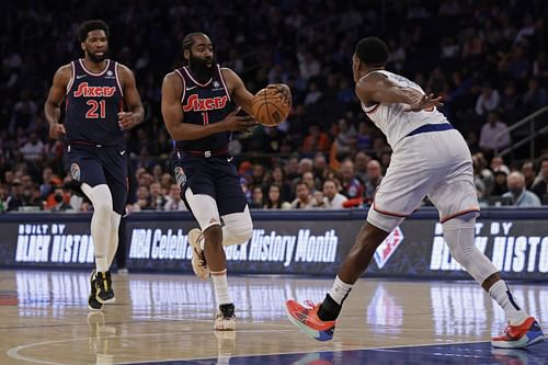 James Harden of the Philadelphia 76ers passes the ball back to Joel Embiid (21) of the Philadelphia 76ers.