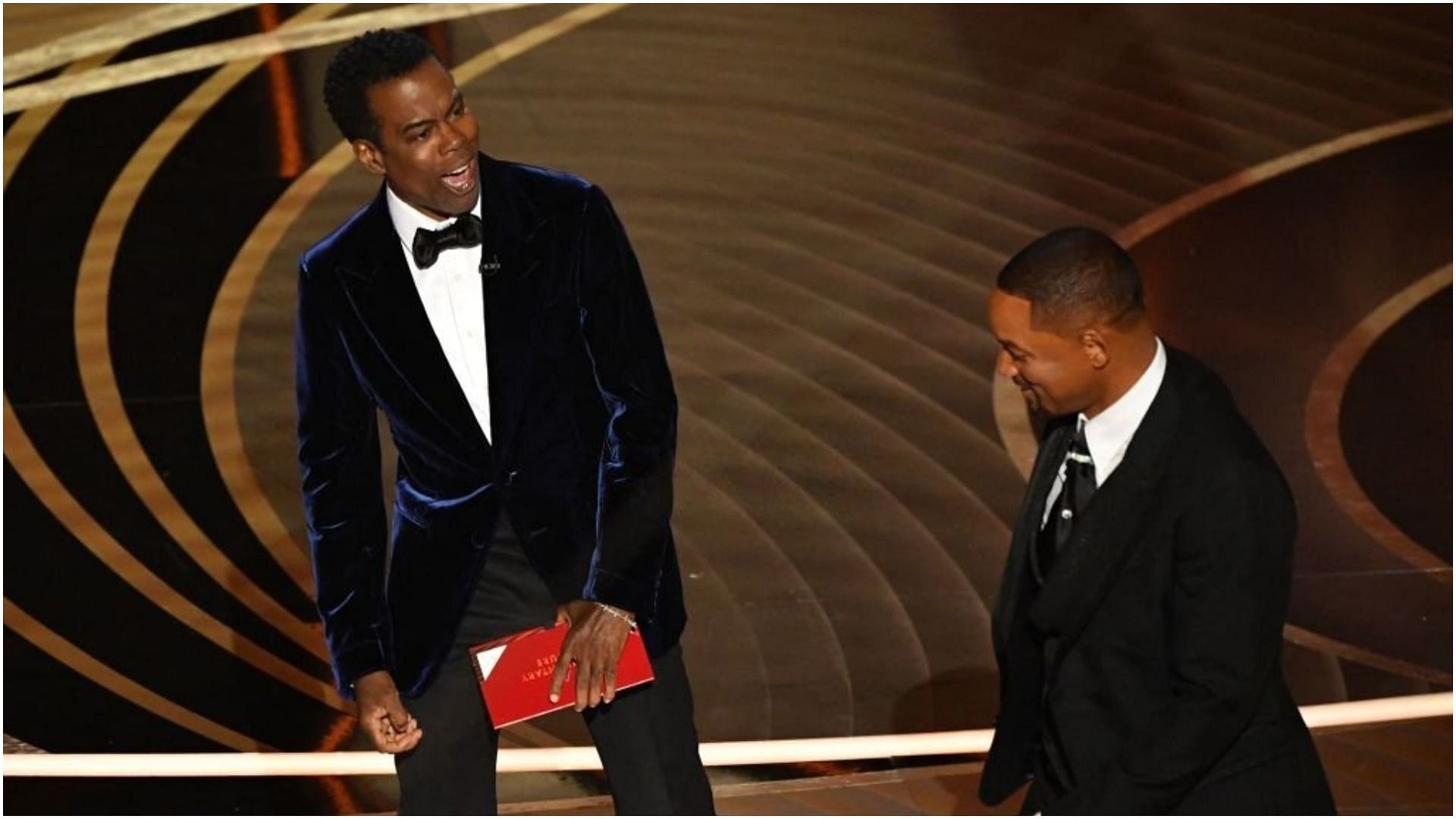 Will Smith approaches Chris Rock on stage during the 94th Oscars (Image via Robyn Beck/Getty Images)