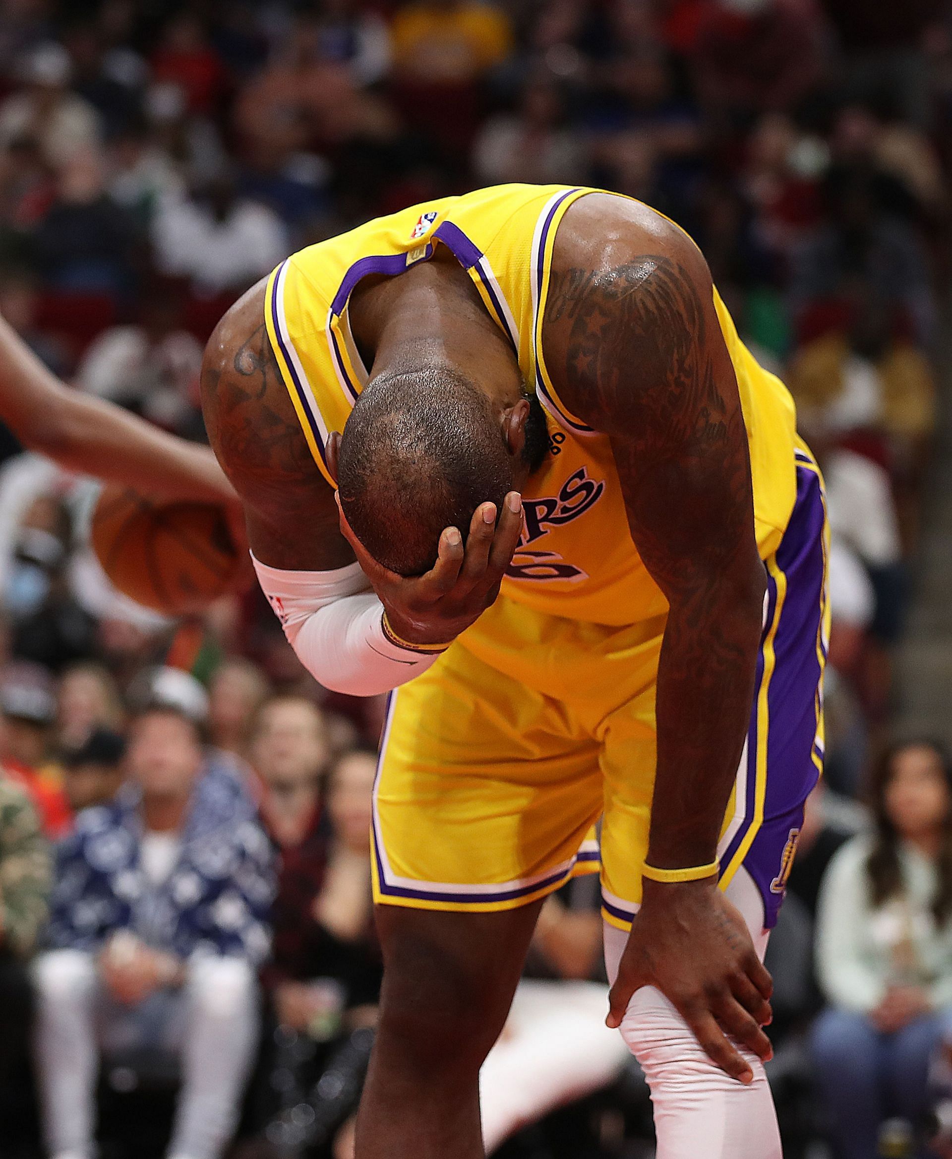 LeBron James of the LA Lakers holds his head after he was hit going to the basket against the Houston Rockets during the fourth quarter at Toyota Center on Wednesday in Houston, Texas.