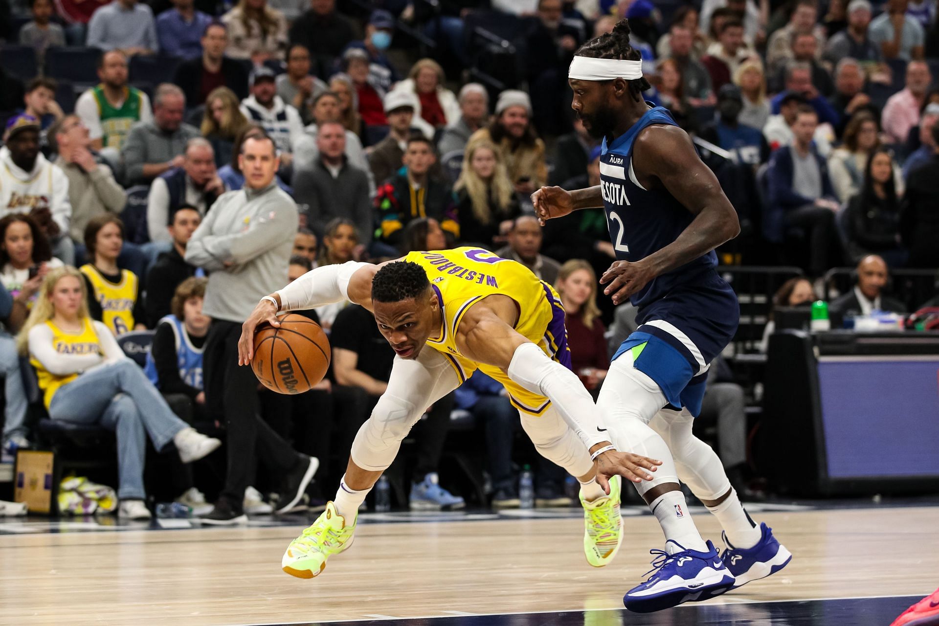 Russell Westbrook #0 of the Los Angeles Lakers drives to the basket while Patrick Beverley #22 of the Minnesota Timberwolves defends