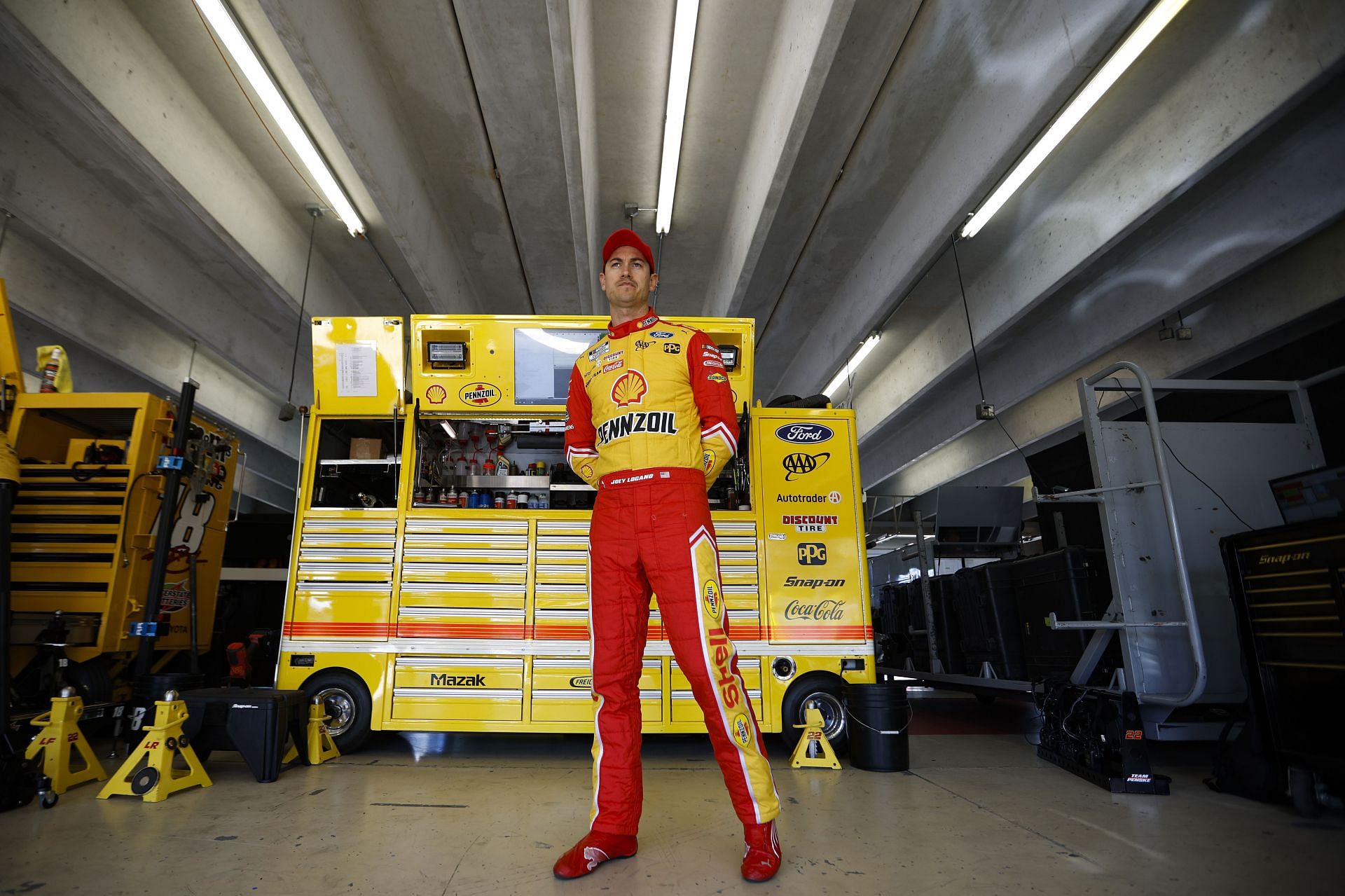 Joey Logano waits in the garage area during practice for the NASCAR Cup Series Folds of Honor QuikTrip 500 at Atlanta Motor Speedway.