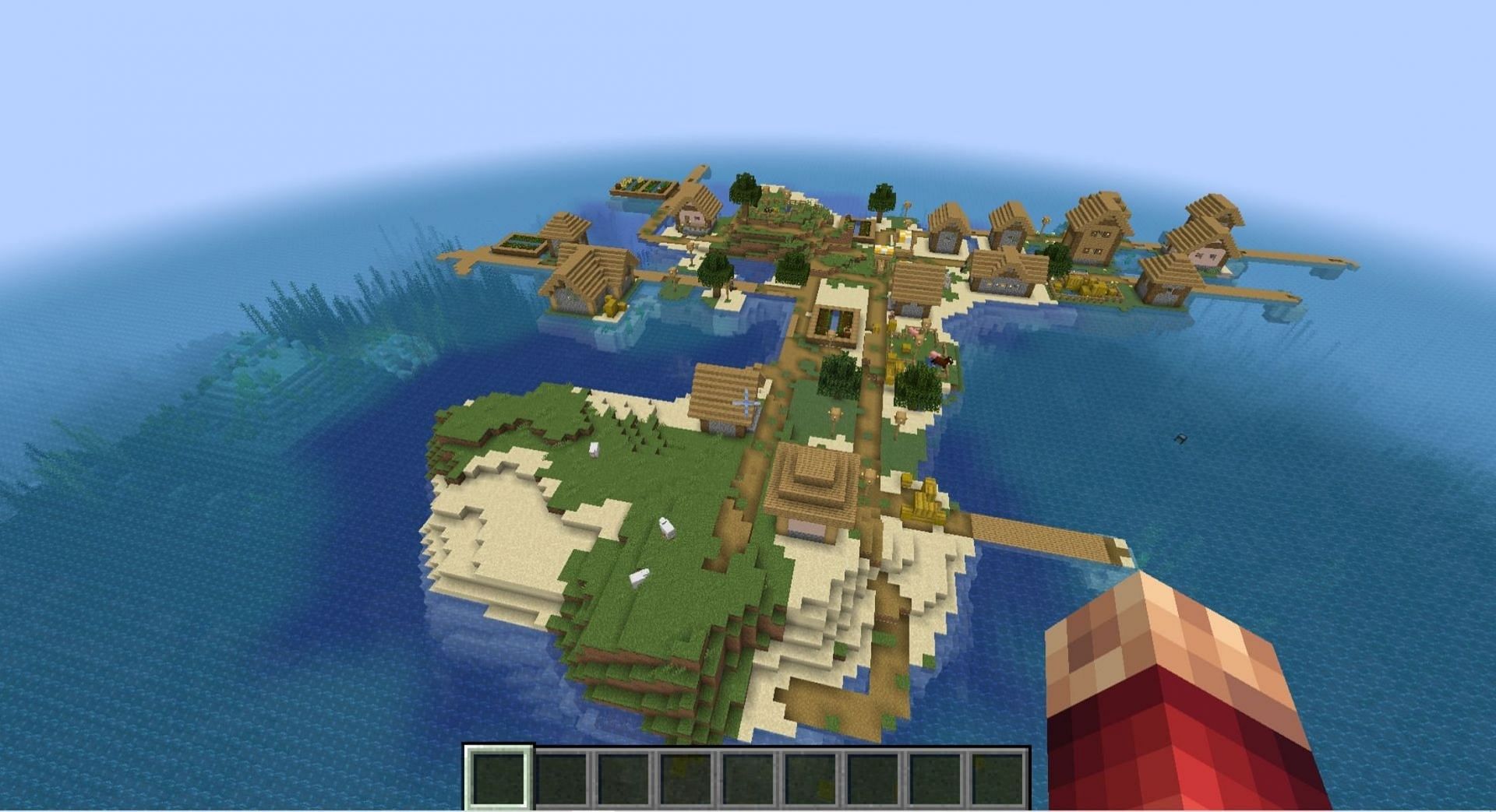 A village and an ocean monument at spawn ensures a treasure trove of seagrass (Image via MinecraftSeeds)