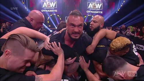 Wardlow being restrained by security guards, this past AEW Dynamite.