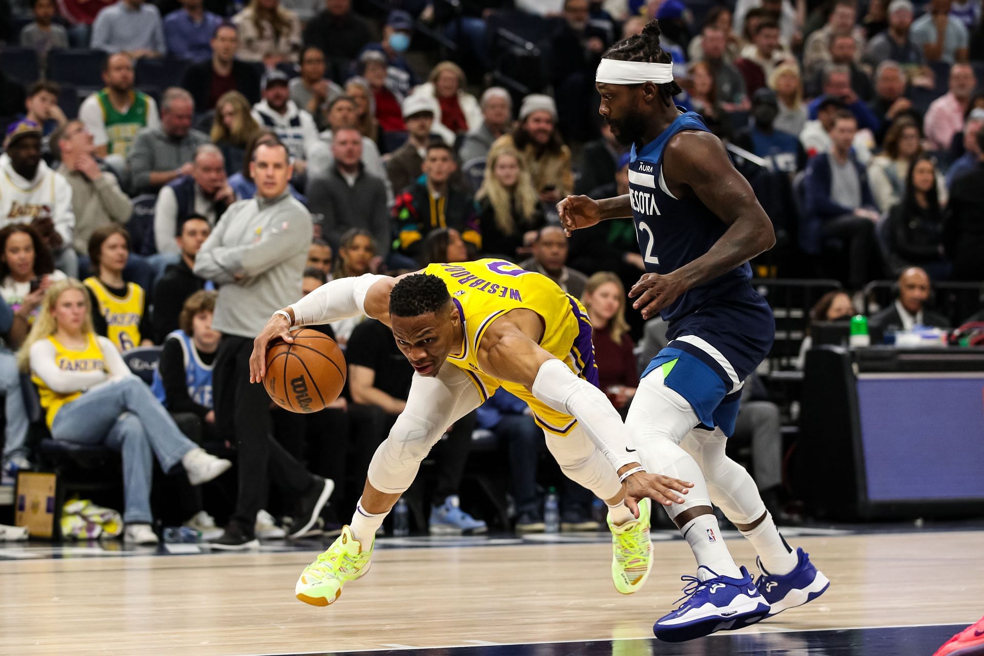 Russell Westbrook #0 of the Los Angeles Lakers drives to the basket while Patrick Beverley #22 of the Minnesota Timberwolves