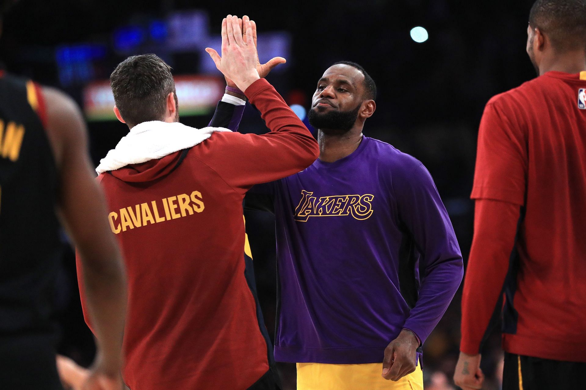 Kevin Love and LeBron James greet each other before a game