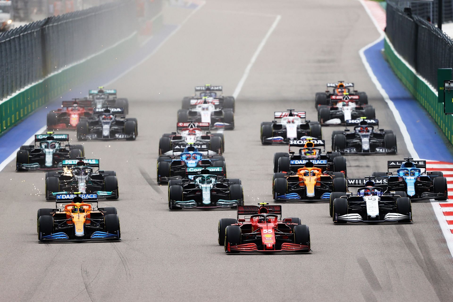 Carlos Sainz (#55), driving the Scuderia Ferrari SF21, leads the field at the 2021 Russian Grand Prix