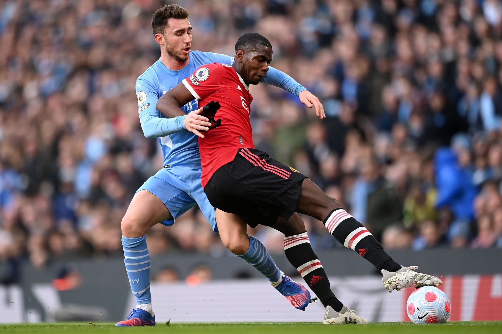 Paul Pogba battles Aymeric Laporte (left) of Manchester City