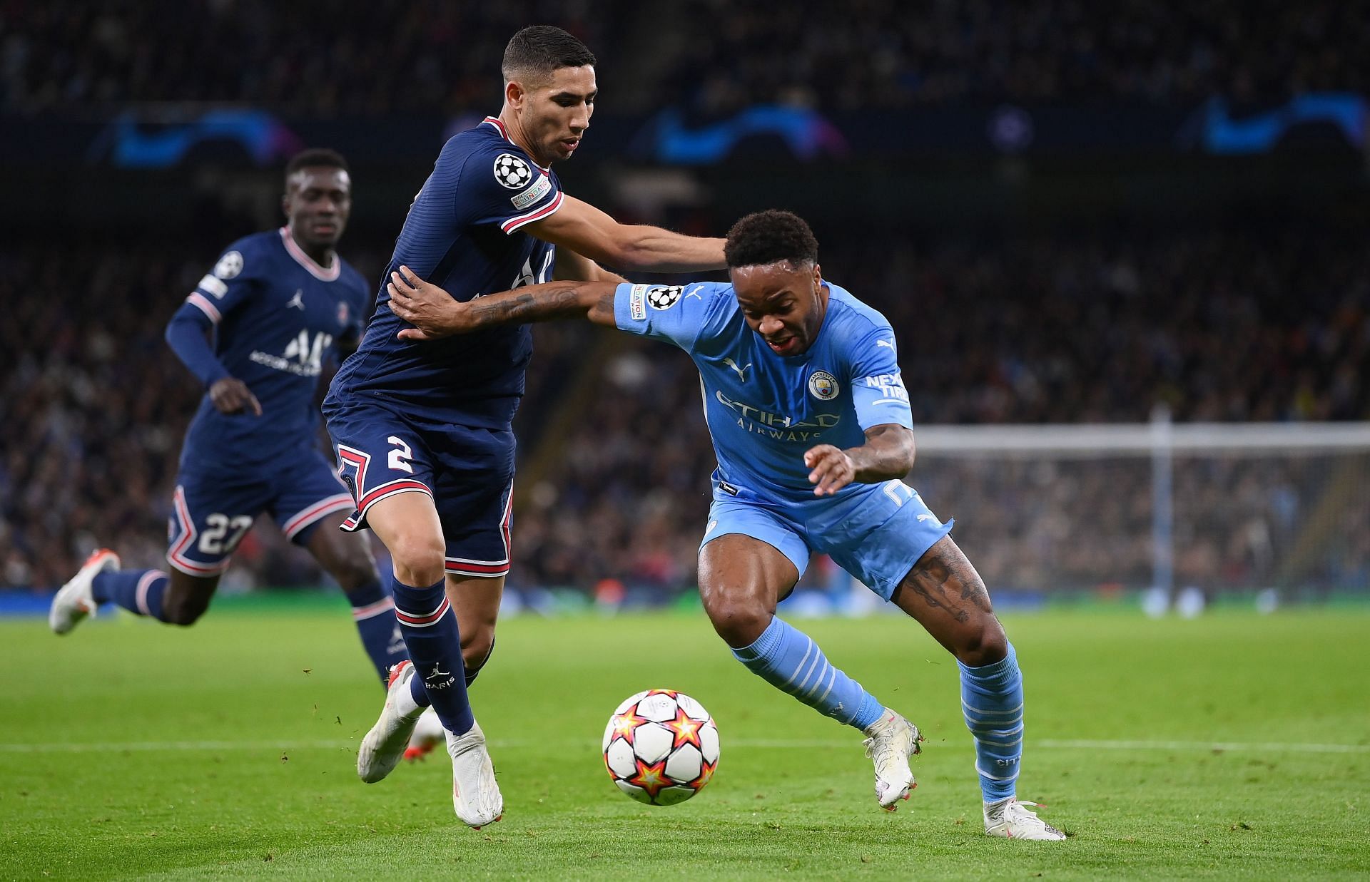 Manchester City&#039;s Raheem Sterling (right) drives at the PSG defence.