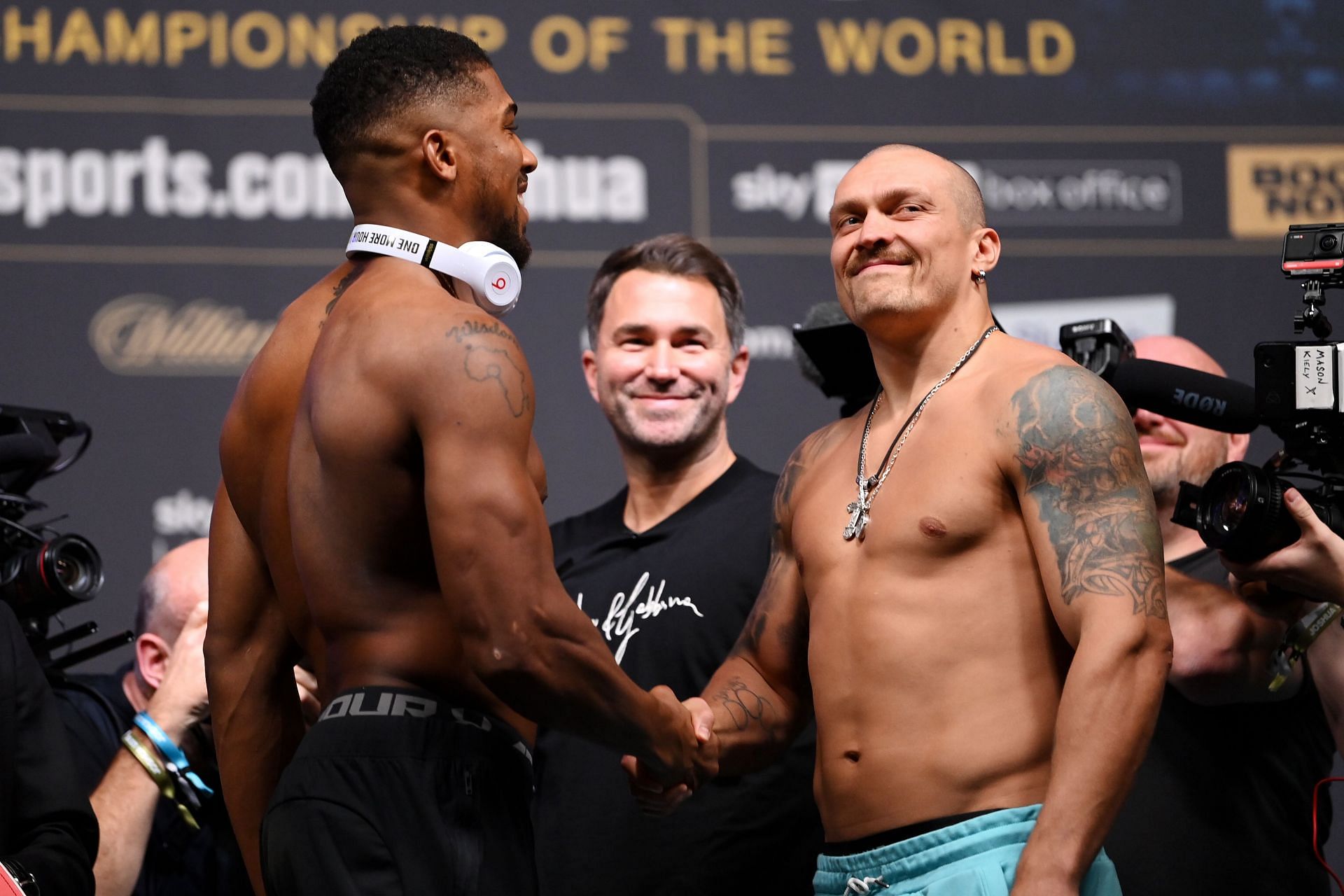 Anthony Joshua (L) and Oleksandr Usyk (R) might not fight next according to Eddie Hearn (M)