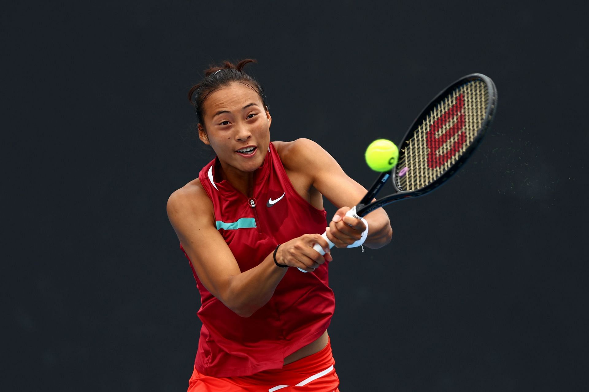 Zheng strikes the ball at the 2022 Australian Open