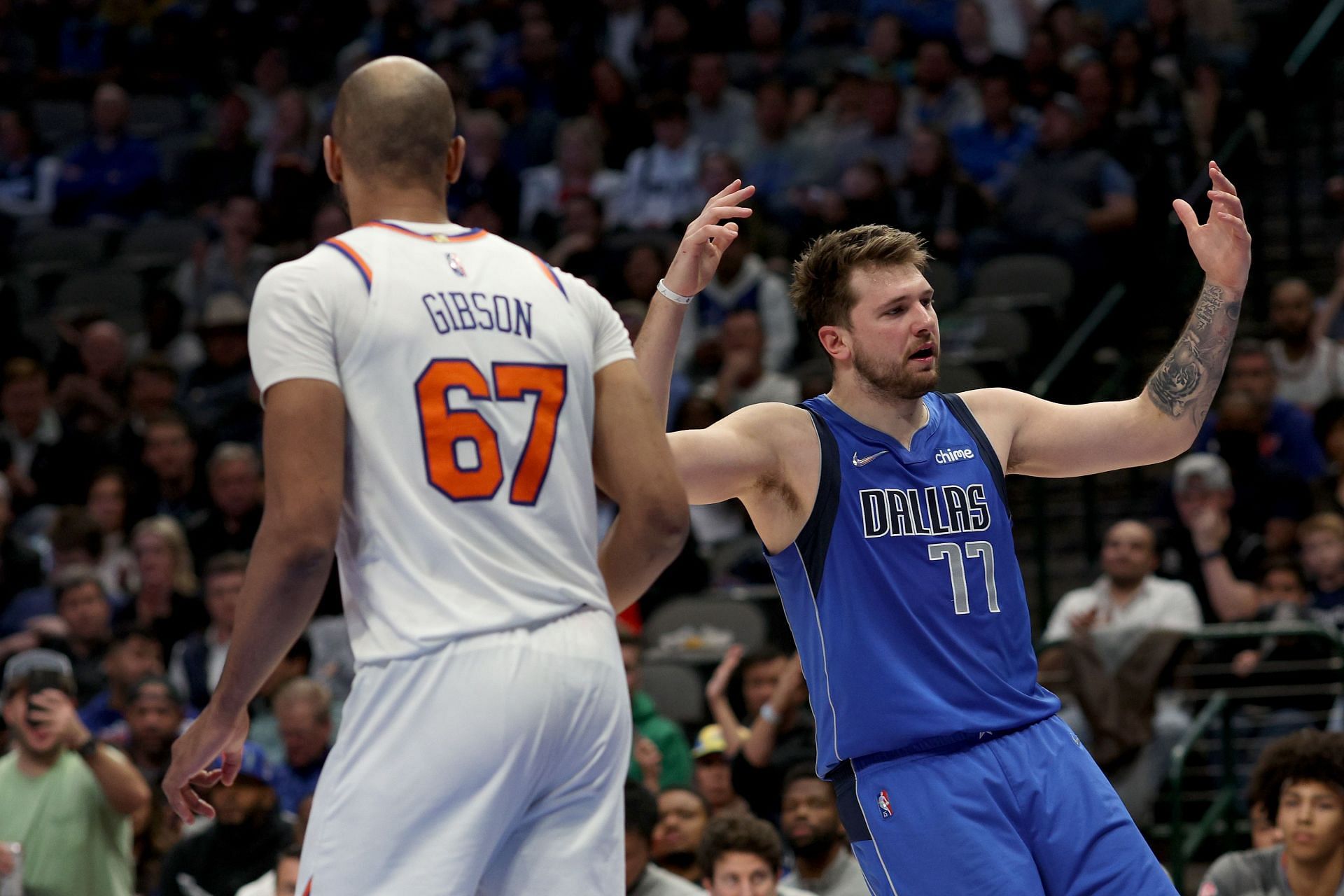 Luka Doncic of the Dallas Mavericks reacts against Taj Gibson of the New York Knicks.