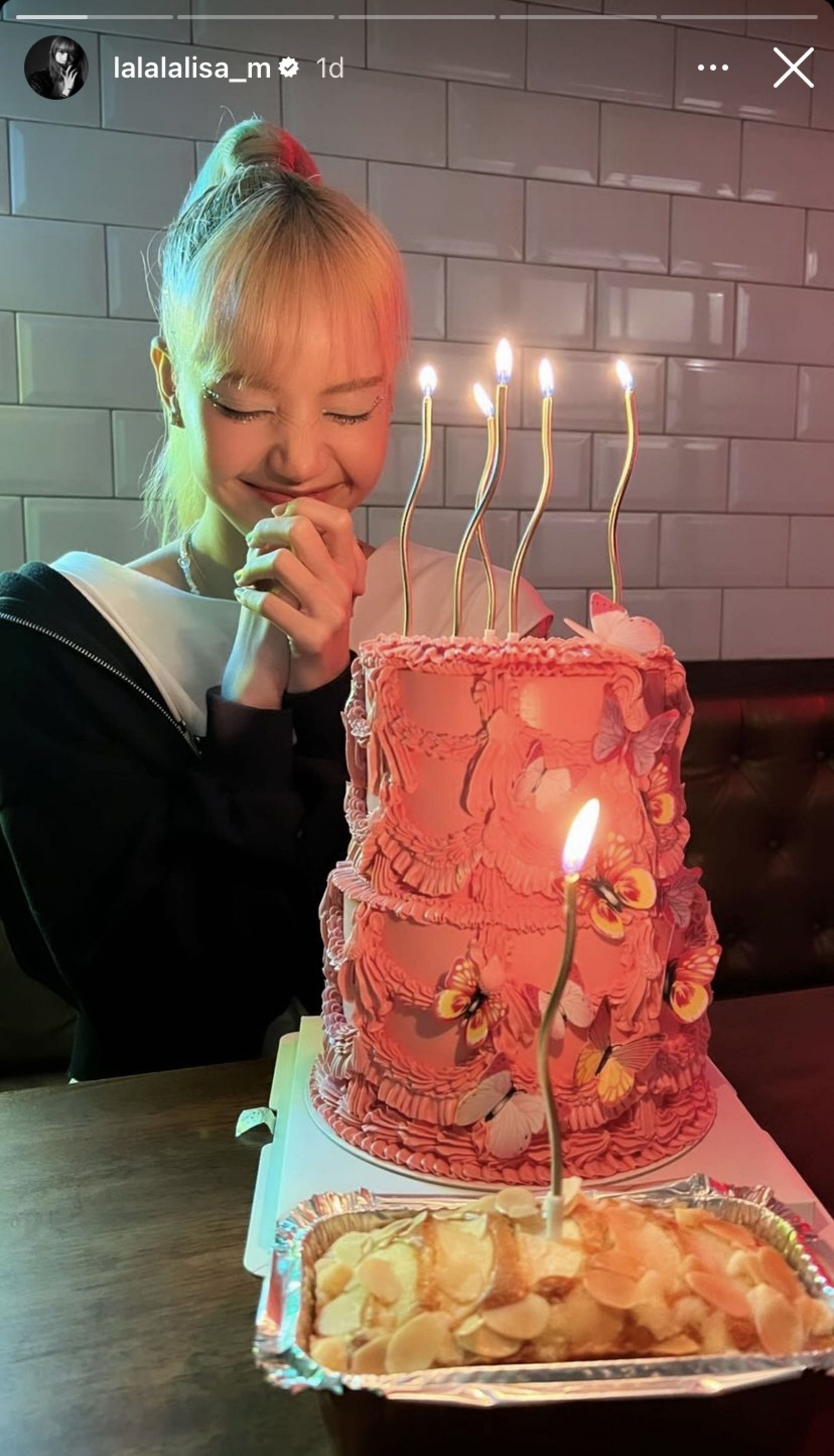 Lisa makes a wish before blowing out the candles (Image via lalalalisa_m/Instagram)