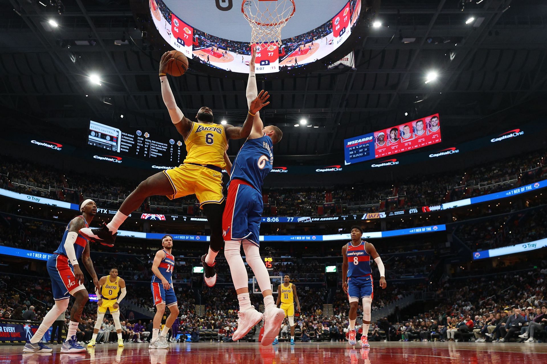 LeBron James #6 of the Los Angeles Lakers shoots the ball against Kristaps Porzingis #6 of the Washington Wizards