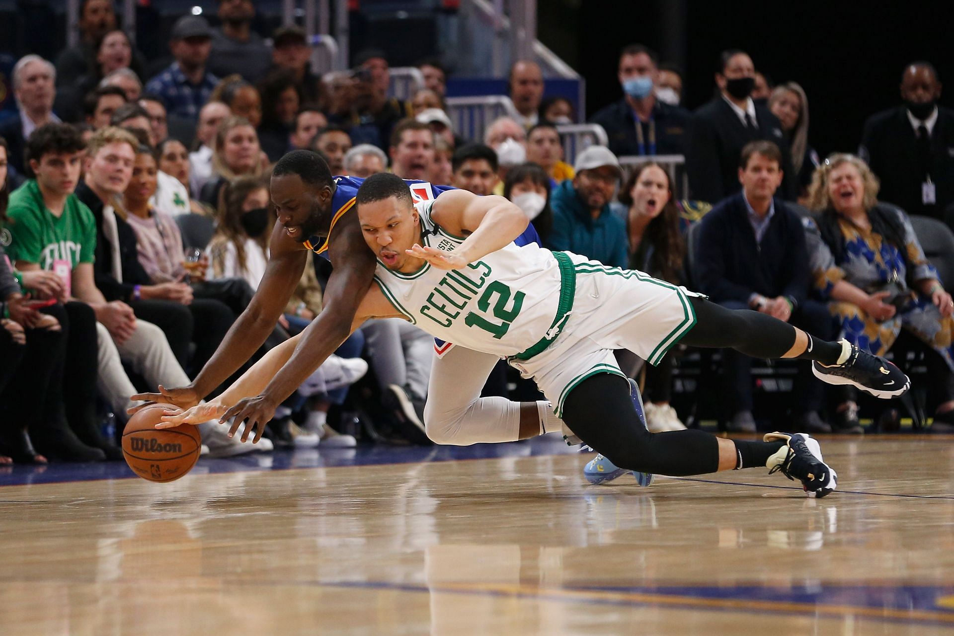 Draymond Green fights for a loose ball against the Boston Celtics.