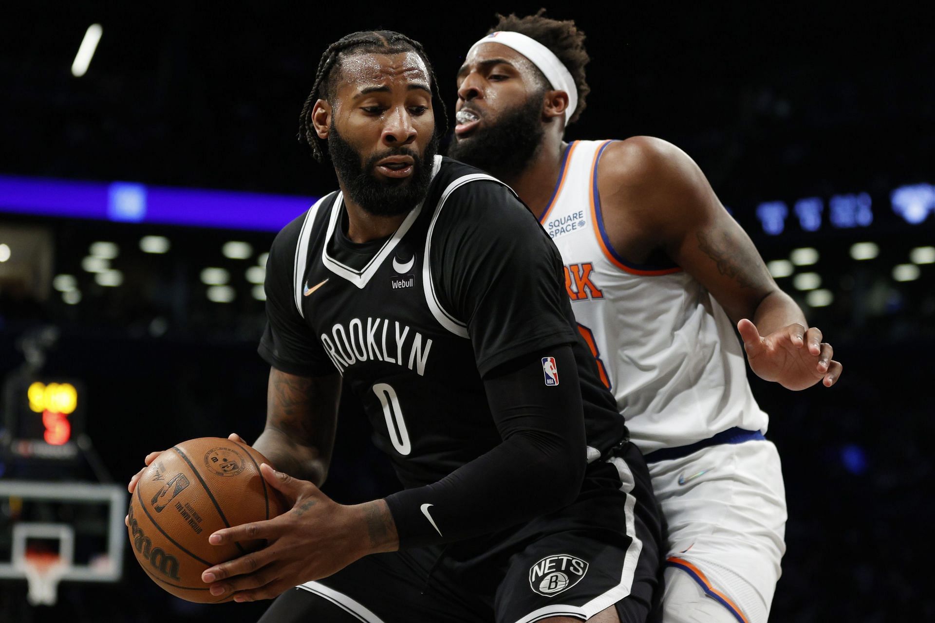 Andre Drummond of the Brooklyn Nets dribbles against Mitchell Robinson of the New York Knicks.