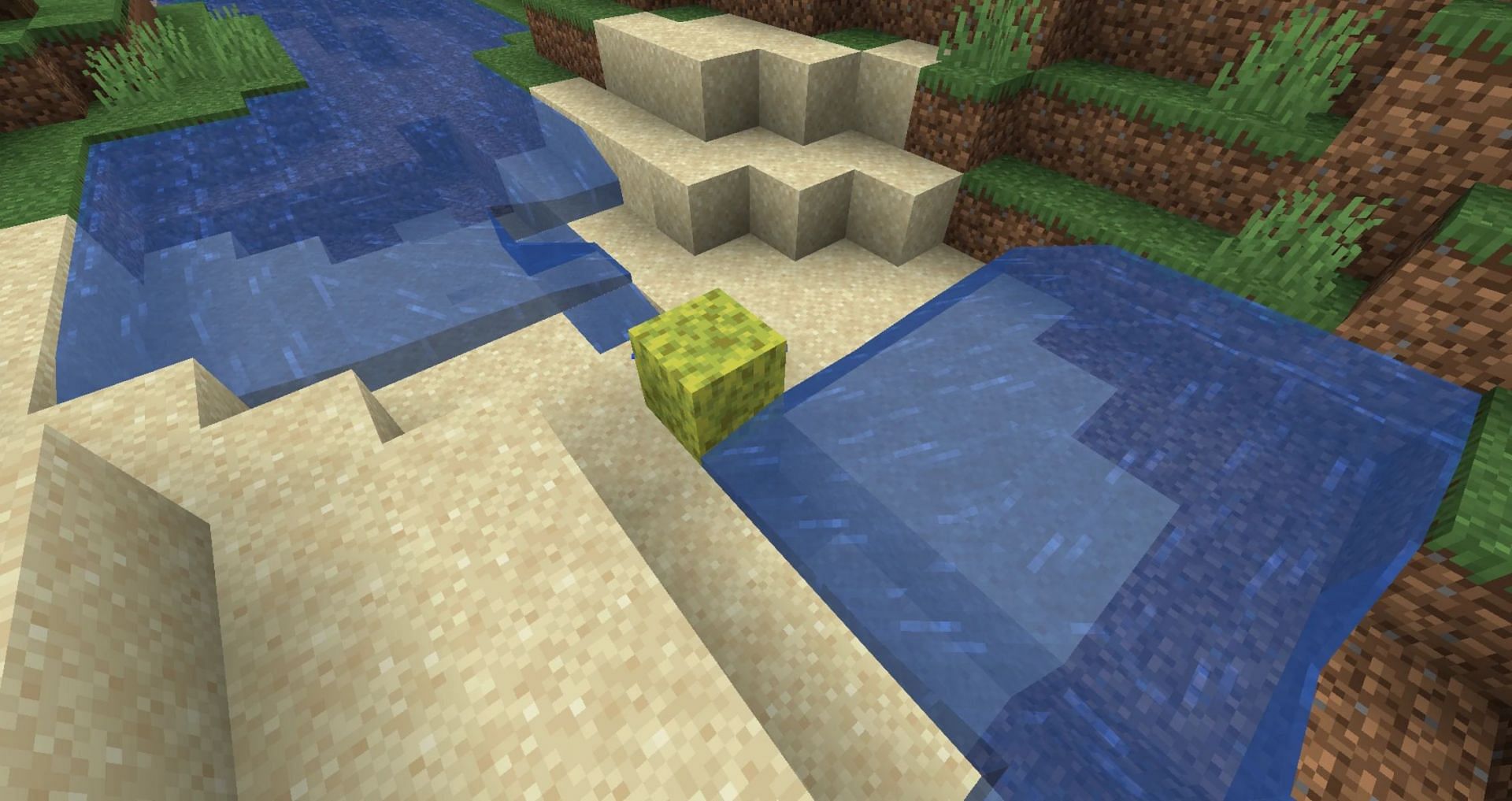 A sponge block cutting through and absorbing the midsection of a body of water (Image via Mojang)