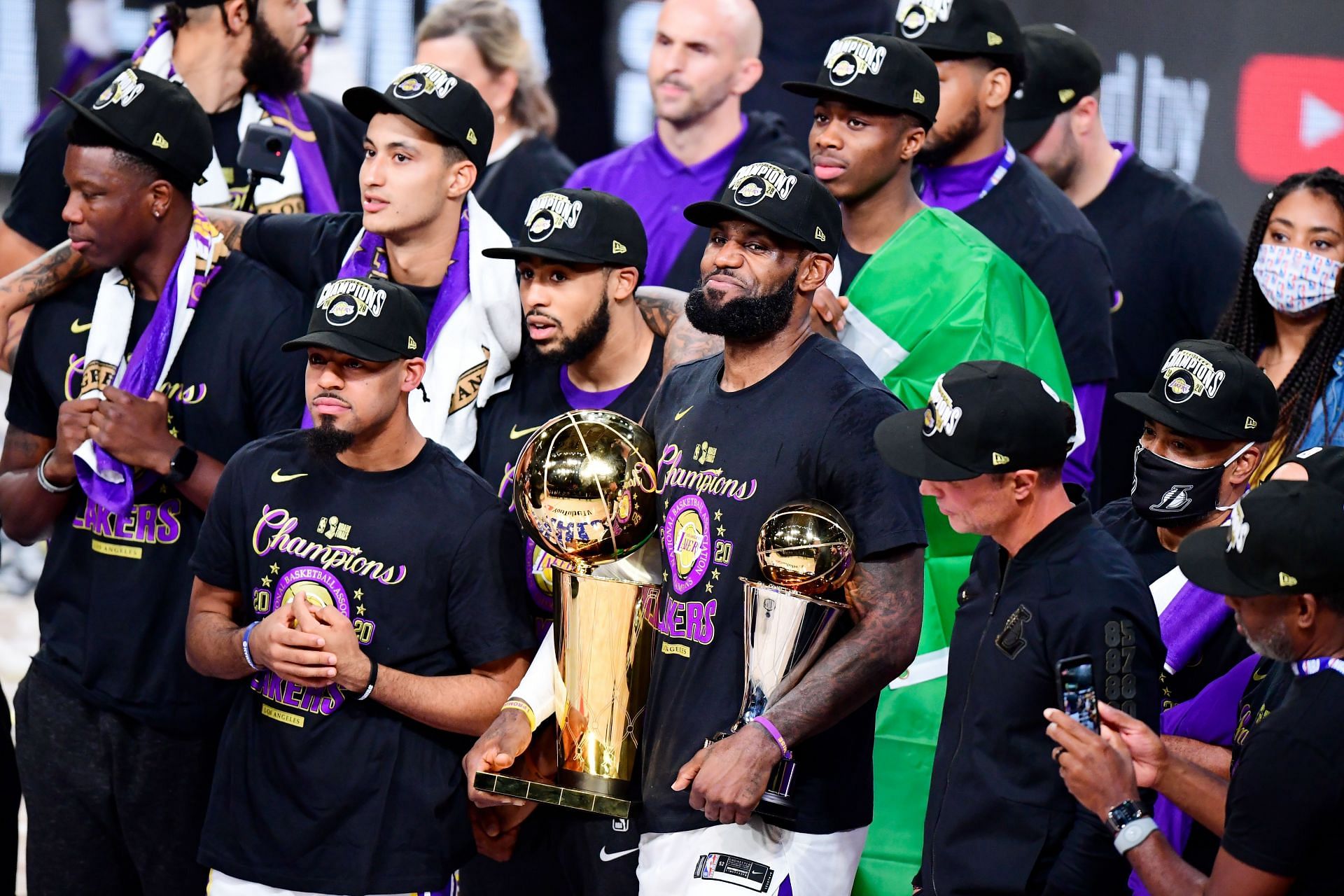 LeBron James of the LA Lakers reacts with his MVP trophy and Finals trophy after winning the 2020 NBA championship.