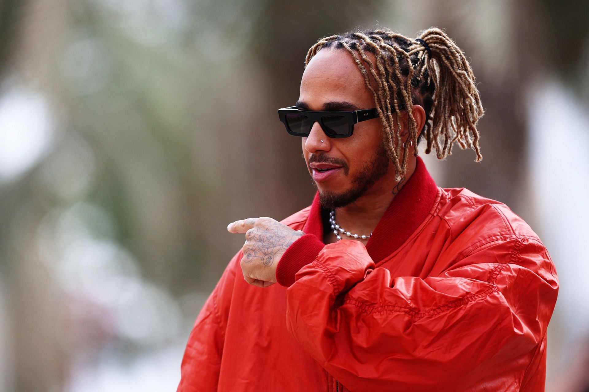 Lewis Hamilton walks in the Paddock during previews ahead of the 2022 Bahrain GP (Photo by Lars Baron/Getty Images)