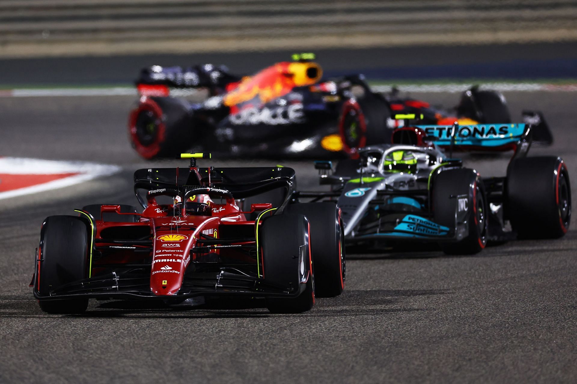 Carlos Sainz (#55) Scuderia Ferrari F1-75 ahead of Lewis Hamilton (#44) Mercedes W13 at the 2022 Bahrain GP