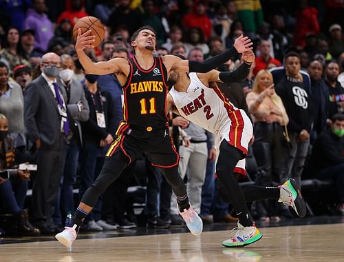 Trae Young receiving contact from Gabe Vincent