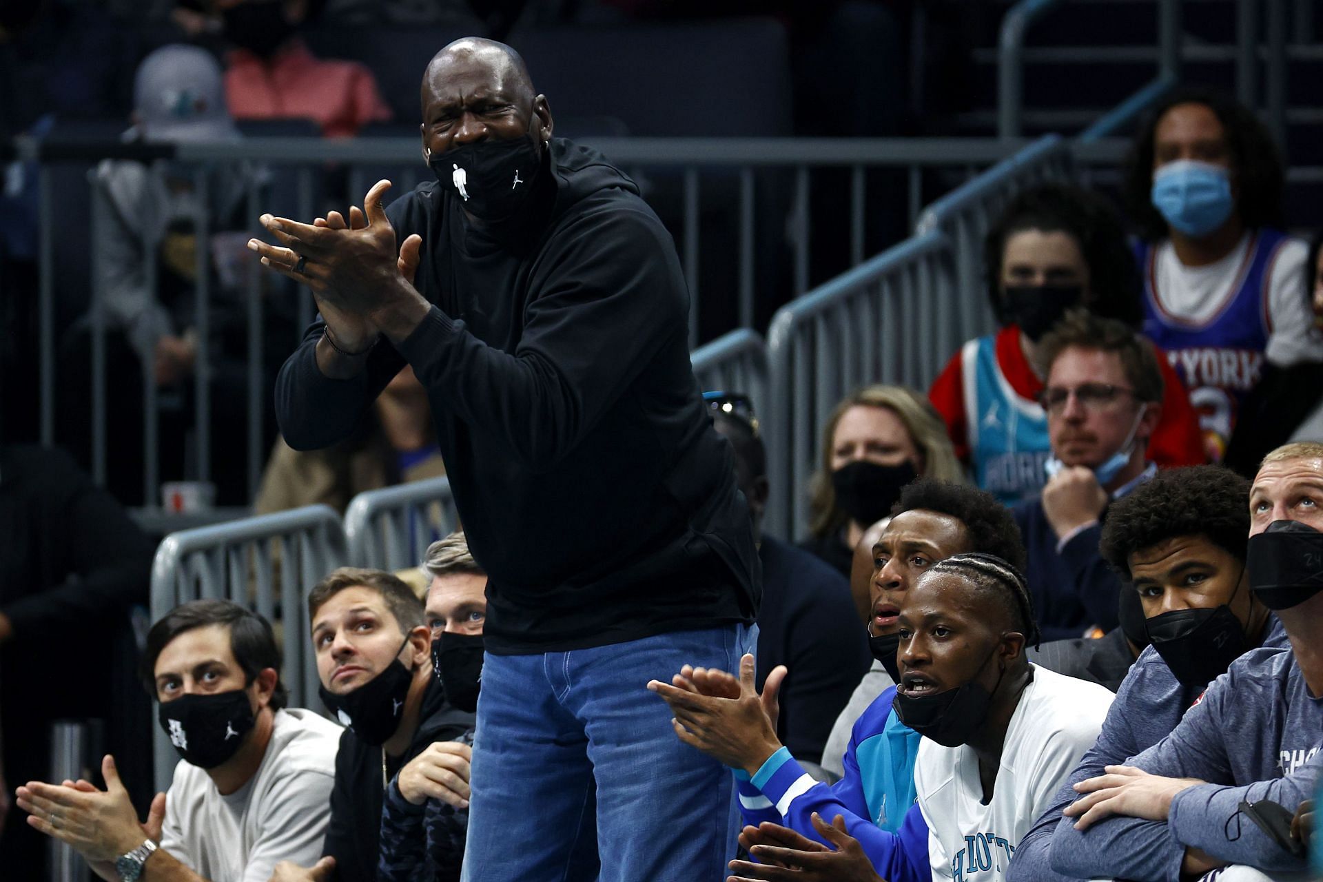 Michael Jordan reacts to a play at a Charlotte Hornets game