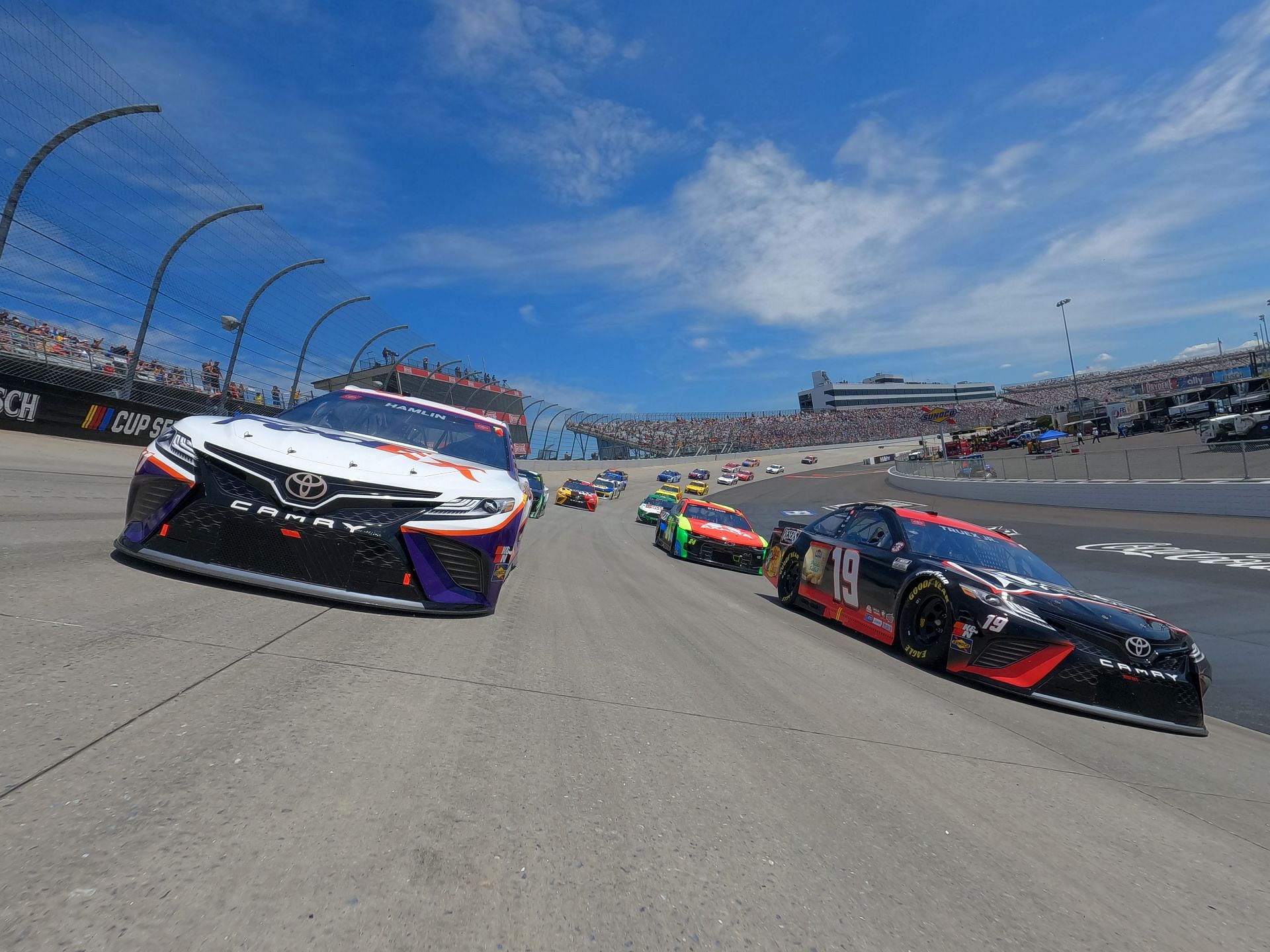 Denny Hamlin and Martin Truex Jr. race during the 2021 NASCAR Cup Series Drydene 400 at Dover Motor Speedway in Dover, Delaware. (Photo by Sean Gardner/Getty Images)