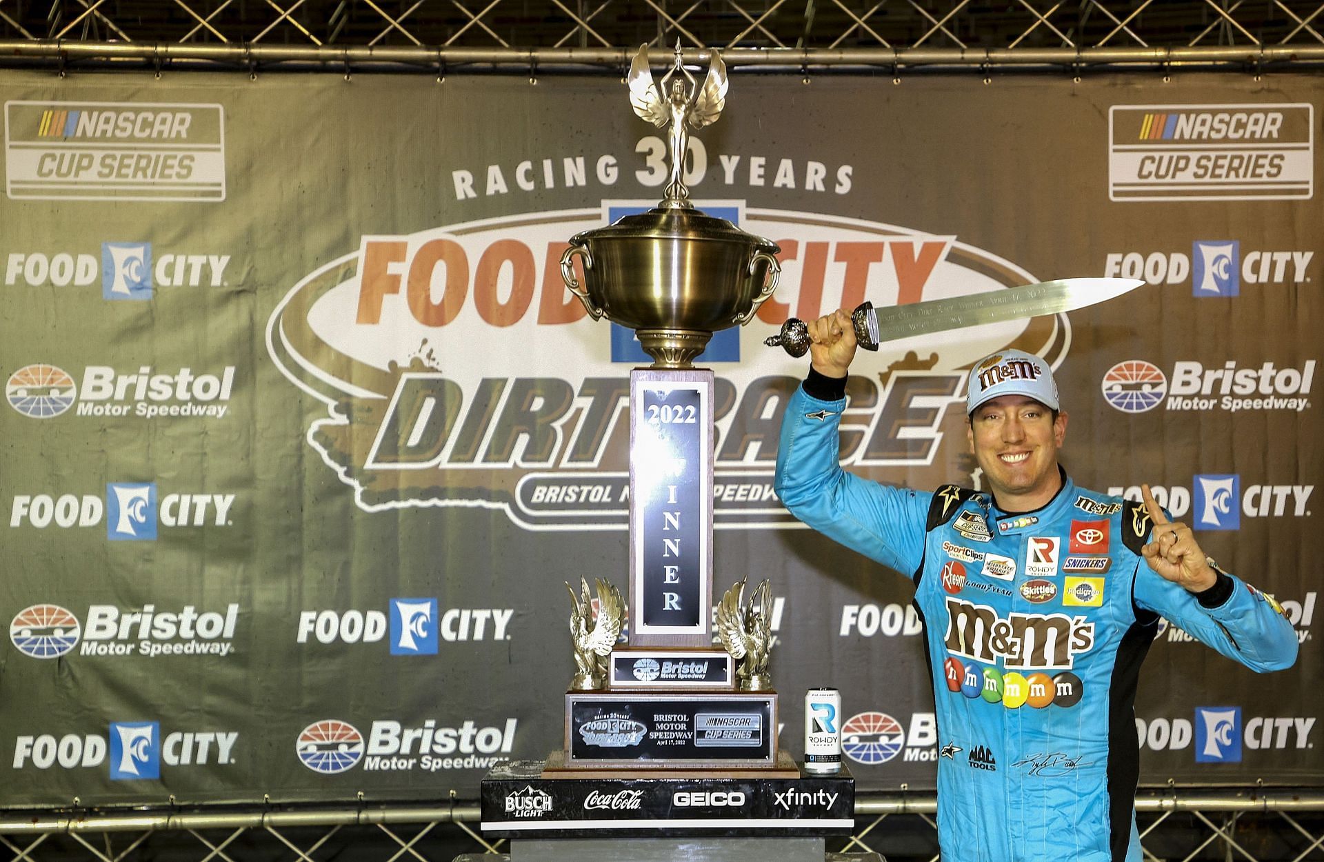 Kyle Busch celebrates in victory lane after winning the NASCAR Cup Series Food City Dirt Race at Bristol Motor Speedway