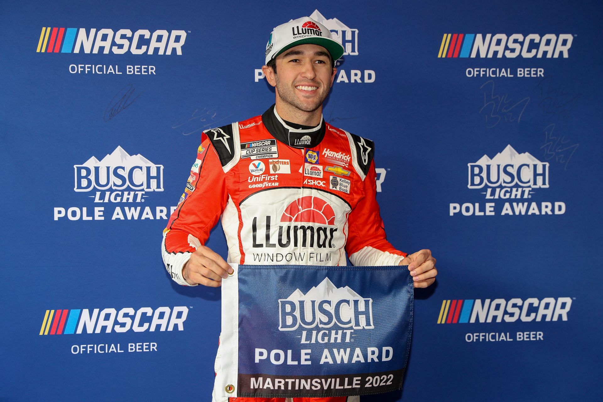 Chase Elliott poses for photos after winning the pole award during qualifying for the NASCAR Cup Series Blue-Emu Maximum Pain Relief 400 at Martinsville Speedway.