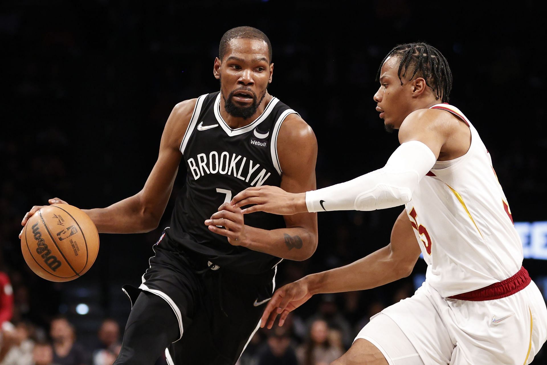 Kevin Durant attempts to drive past Isaac Okoro