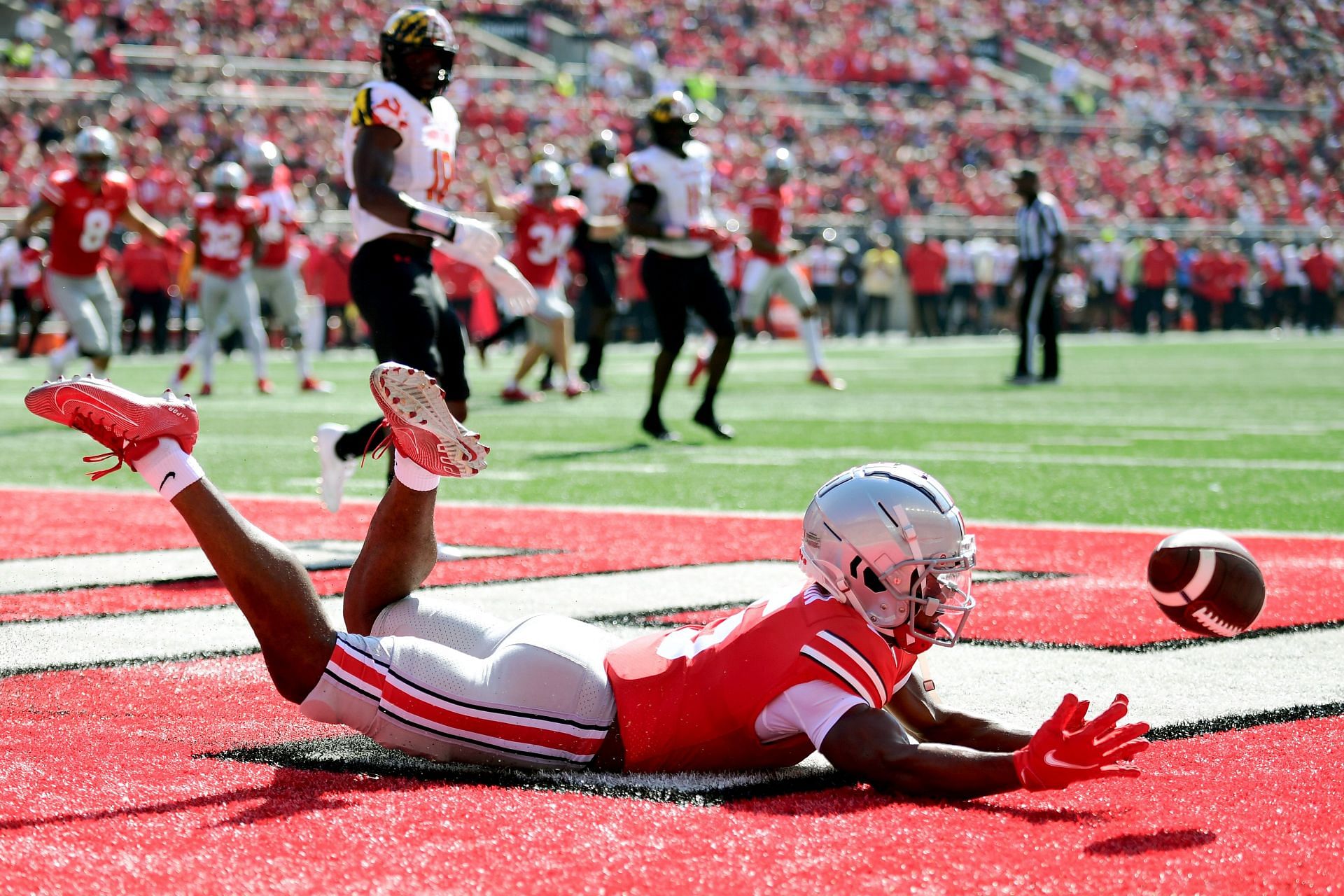 Garrett Wilson #5 of the Ohio State Buckeyes dives to try to catch a pass in the endzone in the first quarter during a game against the Maryland Terrapins at Ohio Stadium on October 09, 2021 in Columbus, Ohio.