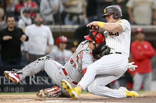 Luke Voit of the San Diego Padres collides with Cincinnati Reds catcher Tyler Stephenson