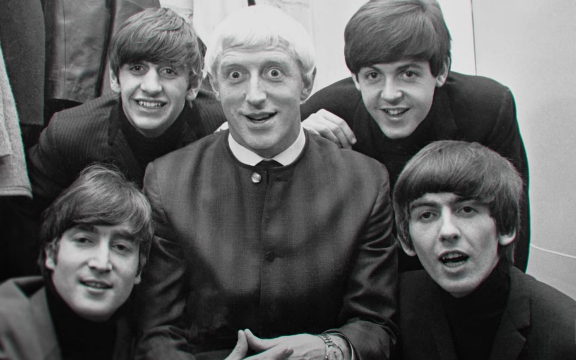 Savile pictured with The Beatles (Image via Netflix/YouTube)
