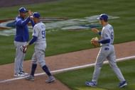 Mookie Betts (middle) and Trea Turner (right) high-five manager Dave Roberts after yesterdays Opening Day victory. Dodgers v Colorado Rockies