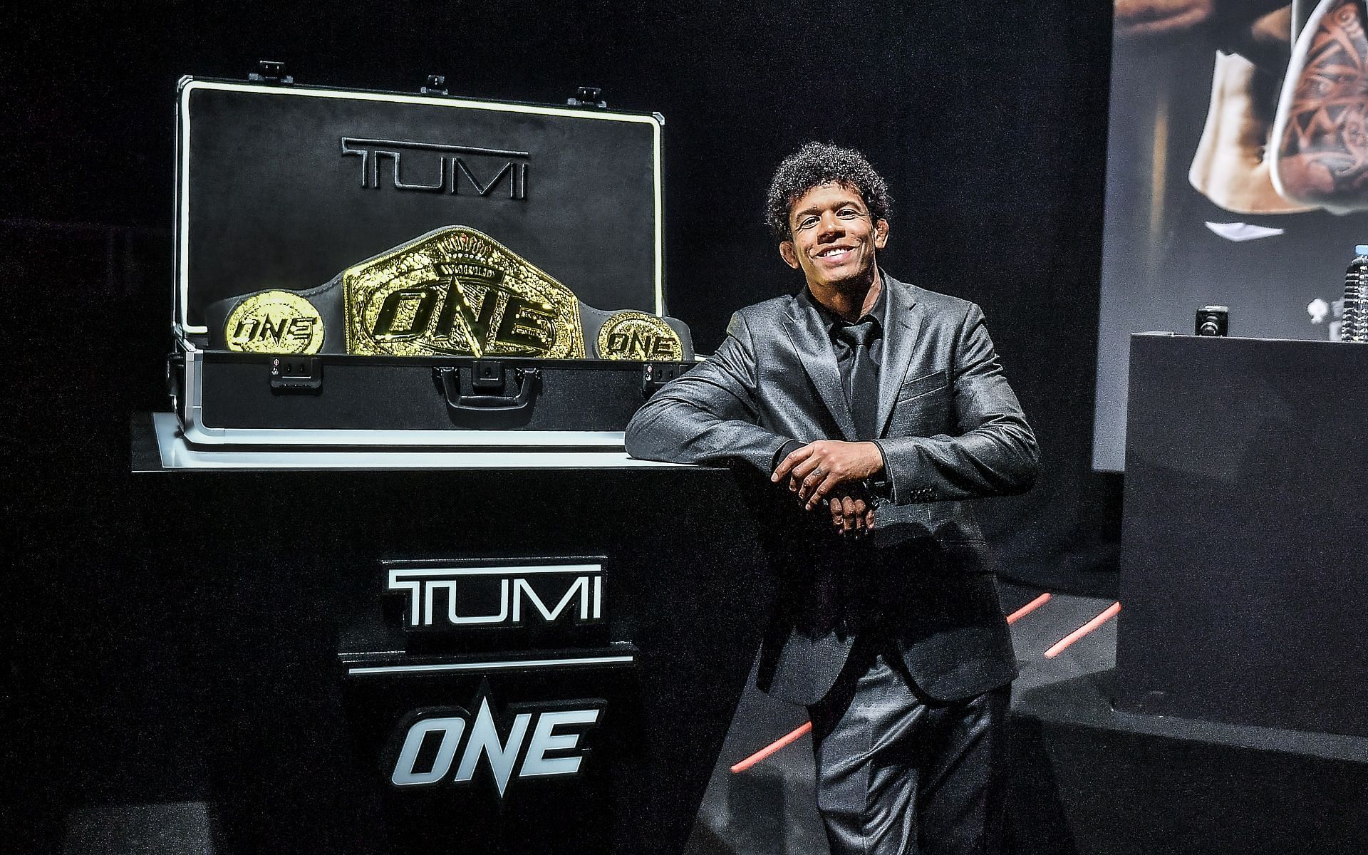 Adriano Moraes poses with the new ONE Championship title belt during the press conference for ONE X. [Photo ONE Championship]