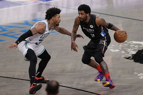 Kyrie Irving #11 of the Brooklyn Nets dribbles as Marcus Smart #36 of the Boston Celtics defends