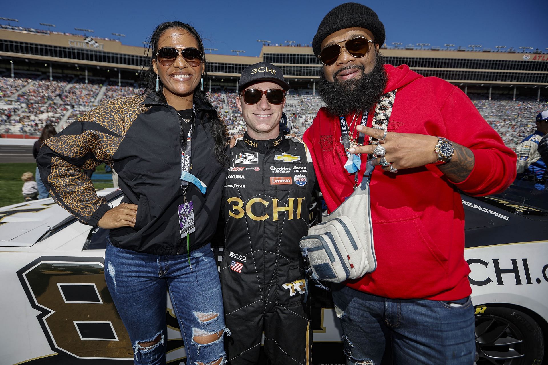 Tyler Reddick (Centre) poses with Bianca Nolden and Blanco Brown at the 2022 NASCAR Cup Series Folds of Honor QuikTrip 500 at Atlanta Motor Speedway. (Photo by Sean Gardner/Getty Images) Enter caption