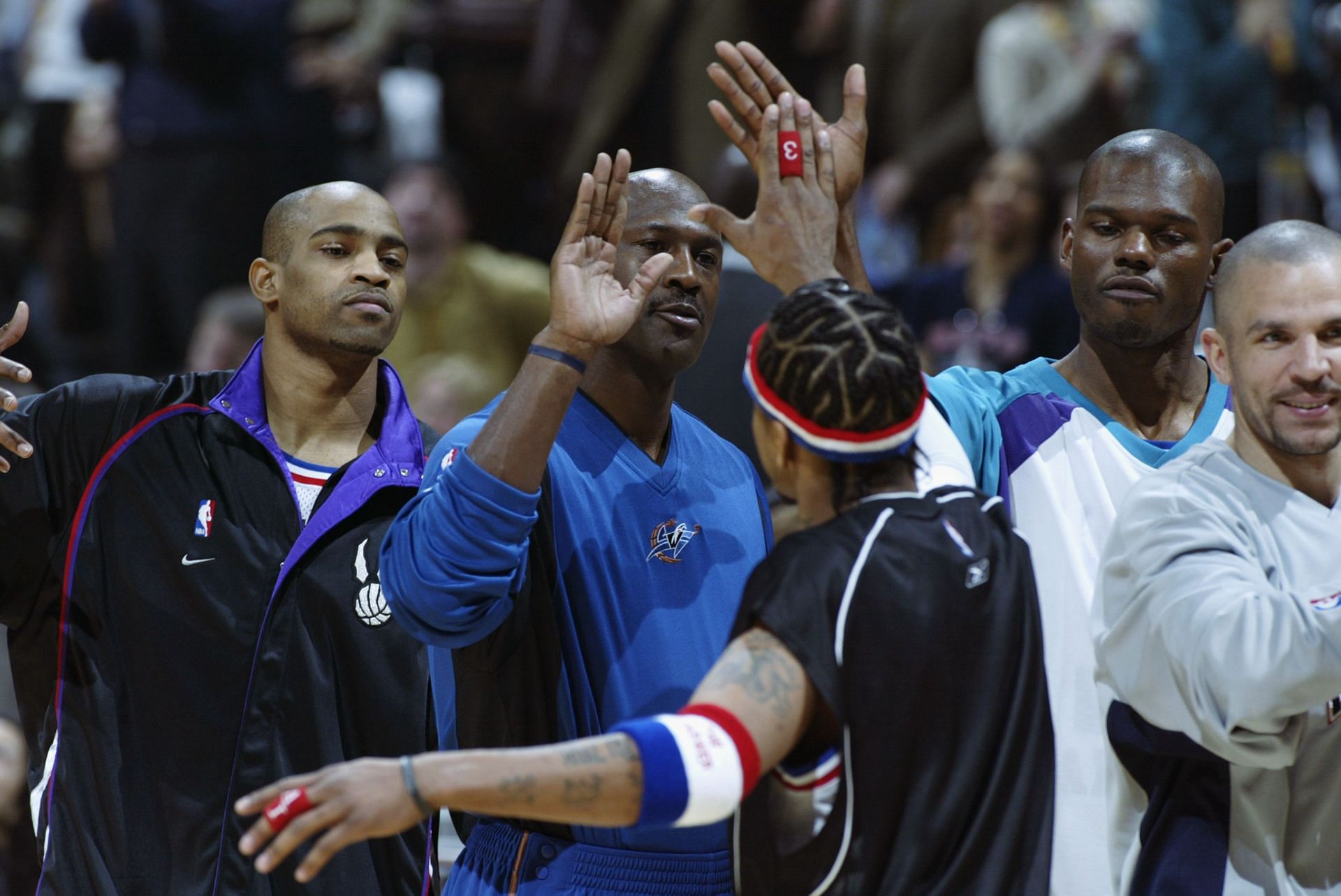 Allen Iverson (Philadelphia 76ers) No. 3 of the Eastern Conference All Stars greets teammates Michael Jordan (Washington Wizards) No. 23.