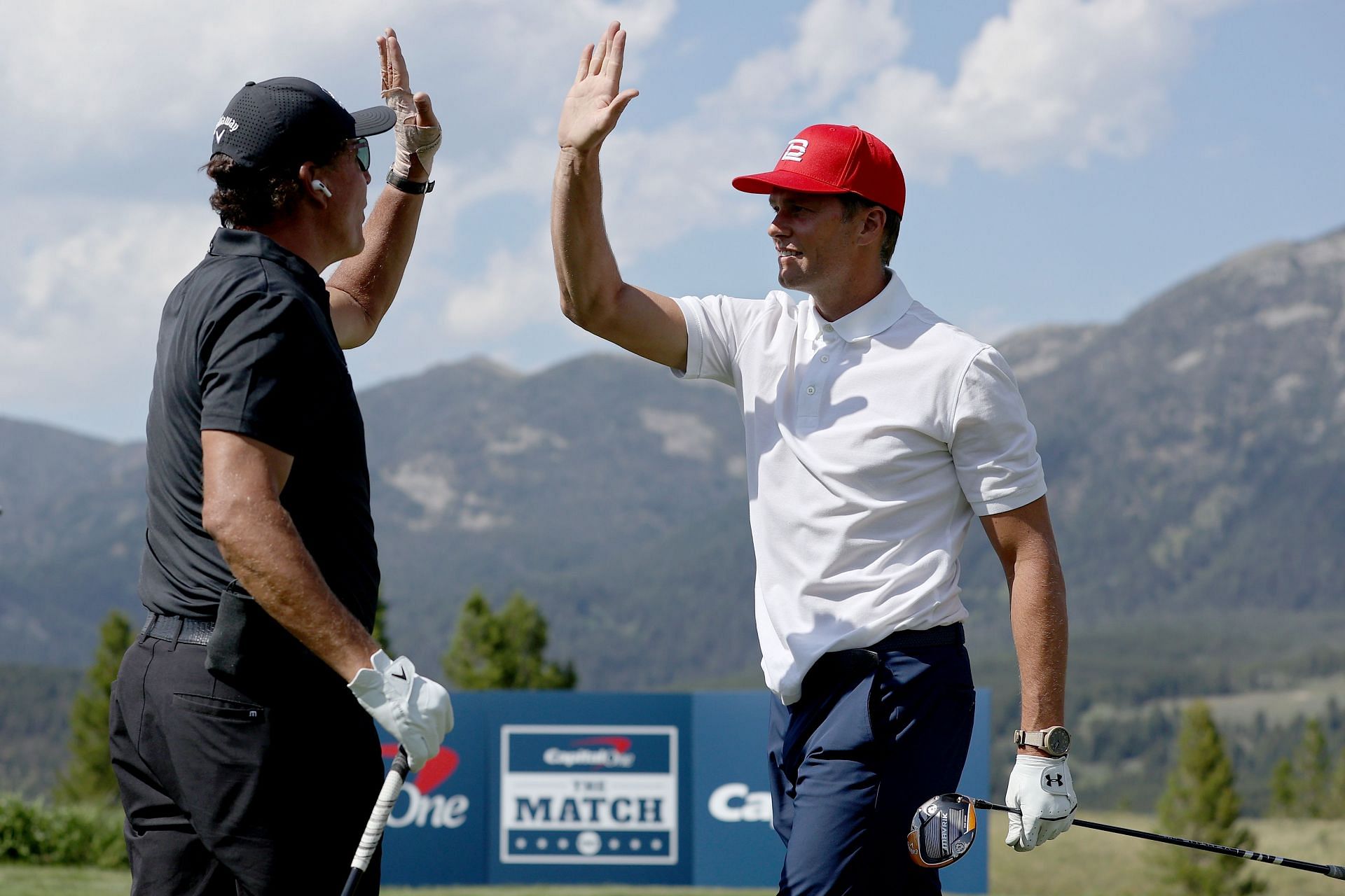 Phil Mickelson and Tom Brady change a high five